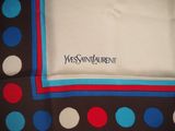 the square scarf has a blue, red, and white polka dot pattern on it