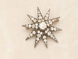 an image of a diamond star brooch on a white background