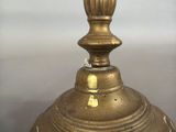 a gold vase with a flower on top of it