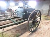 a horse pulling a cart in a barn