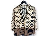 an image of a black and white jacket hanging on a hanger
