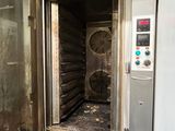 a metal oven with a door open in a room