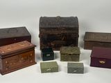 several small wooden boxes are lined up on a white surface