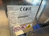 a sign on the side of a refrigerator stating that it is not safe to use