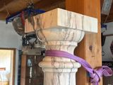 a wooden pole with a purple ribbon on it