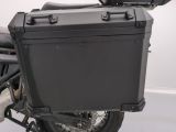 a black motorcycle with a black case on the back of it