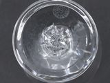 an overhead view of a clear glass with screws in it