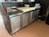a stainless steel counter in a kitchen with a microwave