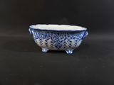 a blue and white bowl sitting on a black table