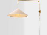 a white lamp on a wall next to a white wall