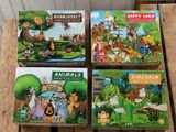 trois livres de puzzles pour enfants posés sur une palette en bois