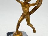 bronze figurine of a boy holding a dog on a marble base