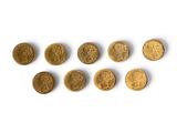 several gold coins are arranged in a row on a white surface