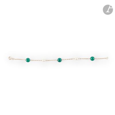 a single emerald beaded bracelet on a gold chain