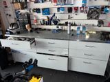 a picture of a workbench in a garage with tools on the wall