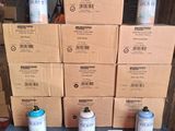 several cans of paint sitting on top of a table next to a stack of boxes