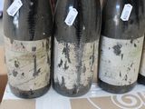 four bottles of wine sitting on a table in a store