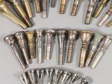 a lot of different types of brass pipes on the table