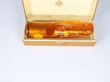 a bottle of alcohol in a box on a white surface