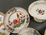 many plates and bowls that are sitting on a table