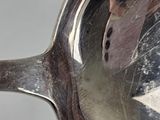reflection of a person taking a picture of themselves in a spoon