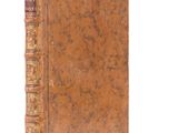 an old book sitting on top of a white surface next to a white background
