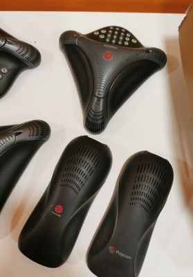 five remote controls in a box on a table