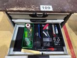 a drawer with tools in it on the floor