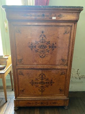 a wooden cabinet that is sitting on a wooden floor