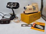 a small camera and some other items sitting on a table