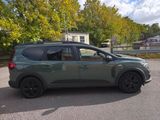 a green suv that is parked in a parking lot
