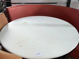 a round table with chairs around it in a room
