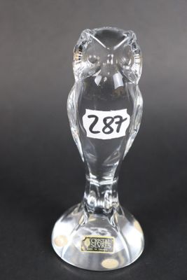 a clear glass owl figurine with a number on it