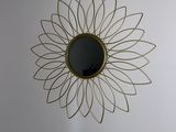 a sunflower shaped mirror on the wall in the room