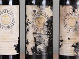 three bottles of wine that are sitting on a table