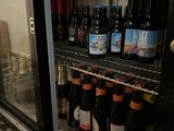many bottles of beer on the shelves in the refrigerator