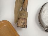 a wooden spatula and a metal pan on a table