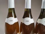 three bottles of wine are lined up on a table