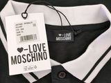 black and white polo shirt with a love moschino tag on it