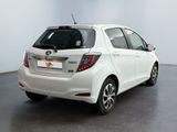 the back of a white toyota yaris parked in a showroom