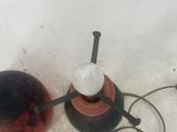 a red and black object on the ground next to a black object