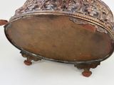 a large metal bowl with a lid on a stand