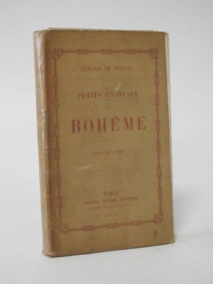 an old book sitting on top of a table next to a white wall