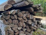 a pile of wood sitting next to a fence