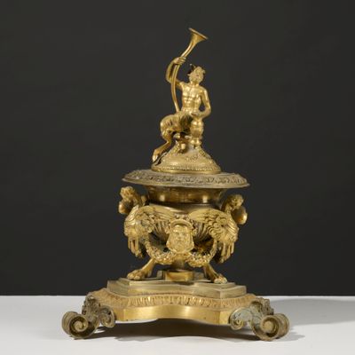 an antique brass figurine of a man on a horse with a trumpet