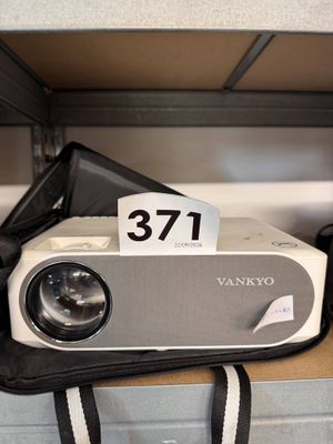 a small projector sitting on top of a shelf in a room