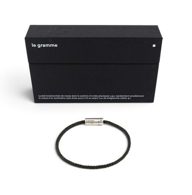 a black bracelet with a silver clasp and a black box