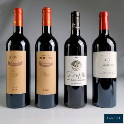three bottles of red wine are lined up on a table