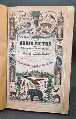 an old book with a picture of animals and birds on it