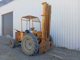 a forklift truck parked in front of a building
